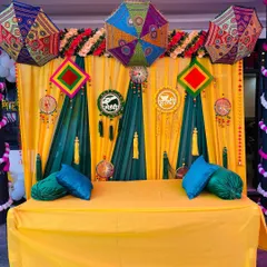 Here you can see the full Haldi and Mehndi setup with a decorated seating area. I can provide a low stool or a larger sofa, ensuring the entire space is coordinated with the backdrop for a complete look.