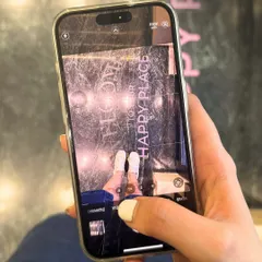 Capturing the moment from your point of view. A client takes a picture of her fresh white manicure against our "Happy Place" floor art, a perfect souvenir from her solo pamper session.