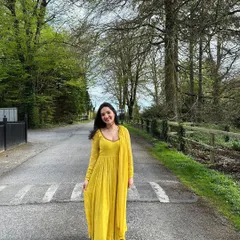 A full-length view of the yellow corset anarkali set, showing its flattering fit and beautiful color. This piece can be customized in any color and size.