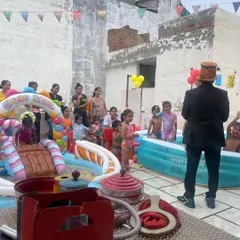 We can set up a complete pool party with multiple inflatable pools, including one with a slide. I'm here entertaining the kids who are taking a break from the water.