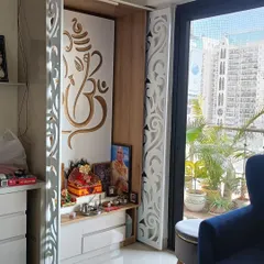 We designed this beautiful pooja corner with CNC-cut jaali doors featuring a Ganesha motif. It provides a serene space for worship while integrating seamlessly with the home's decor.