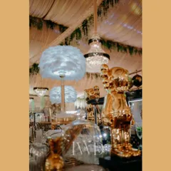 Eclectic and quirky details on the bar, including feather lamps and golden figurines, added a touch of modern art to the 'Midsummer Night's Dream' theme.
