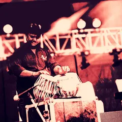 An artistic, red-tinted photo of me playing on a professionally lit stage. This image captures the high energy and modern aesthetic of a large scale fusion music concert.