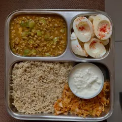 An excellent eggetarian high-protein meal with quinoa, green gram dal, boiled egg whites, sautéed cabbage, and a side of curd.