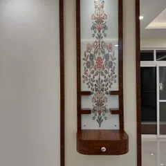 A compact and elegant wall-mounted pooja unit for Milanshu and Geetika's home. The floral patterned glass and wooden frame create a modern yet traditional sacred space.
