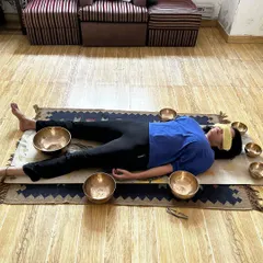 A private sound healing session where Tibetan bowls are placed around the body. The vibrations from the bowls travel through the body to release tension and balance the chakras.