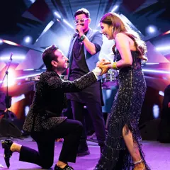 After the vows, the party begins. For this cocktail after-party, the groom serenades his bride on stage. Her midnight blue embellished gown by Shantanu & Nikhil was styled for glamour, movement, and a whole lot of fun.