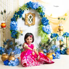 This little Radha is all smiles in our beautiful Vrindavan-inspired set. The bright pink lehenga stands out beautifully against the blue and gold decor.