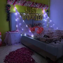 Another view of the first-night room decoration, showing the beautiful path of rose petals leading to the bed.