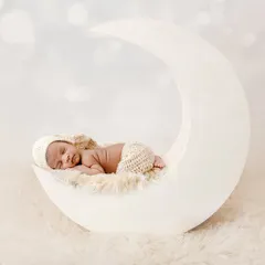 A journey to the stars on my custom moon prop. This dreamy, all-white setup is a client favorite, creating serene and angelic portraits that feel timeless. The soft textures and lighting are designed to highlight your baby's delicate features.