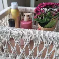 Here’s the basket used as a stylish organizer for toiletries and skincare products, adding a soft, natural touch to a bathroom counter.