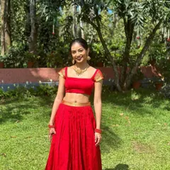 For a bold and joyful celebration, I designed this vibrant red crop top and skirt set. The modern silhouette with a square neckline is balanced with traditional gold detailing on the sleeves, creating a perfect fusion look for a Sangeet or pre-wedding event.