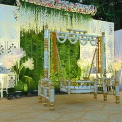 Every detail matters in creating a beautiful setting. This view shows the decorated cradle, the large paper flowers, and the lighting fixtures I used to enhance the overall stage design for this naming ceremony.