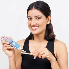 Showing a product in use is key to helping customers envision it in their own lives. This lifestyle shot for a toothpaste brand features a model with a genuine, bright smile, instantly communicating freshness and effectiveness.