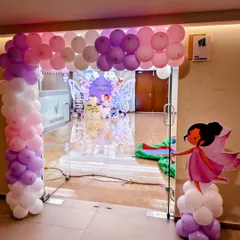 A beautiful balloon arch in shades of pink and purple marks the entrance to Prashi's butterfly-themed birthday party.