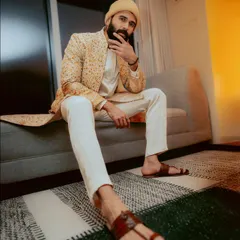 This is a perfect example of a 'warm' toned look. The earthy, golden yellow of this jacket on Vijay Deverakonda enhances his complexion and gives him a natural glow.