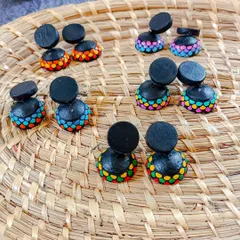 A collection of my colorful terracotta jhumkas. These two-part earrings feature a simple black stud connected to a vibrant, multi-colored dome.