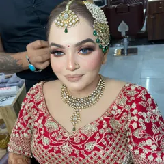 A close-up of Dipika's bridal makeup before the final touches. The focus is on her glowing skin and the beautifully defined eyes, paired with a neutral lip to balance the heavy jewelry.