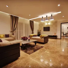In this living room, we used handcrafted tiles to create a textured feature wall for the television. This detail adds warmth and character to the space, complementing the glossy marble floors and sophisticated furniture.