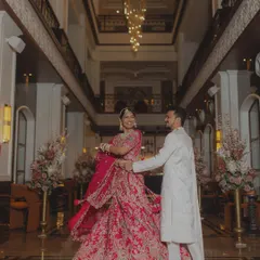 A twirl in the grand lobby of a luxury hotel. The bride's magnificent lehenga and the stunning chandelier create a picture of pure elegance and celebration.