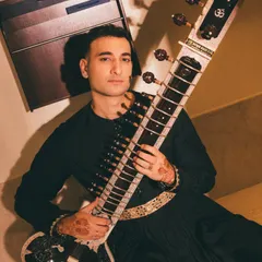 A direct and confident pose from the 'Sitar Sorcerer' photoshoot. My goal is to connect with the audience, both through my music and my presence.