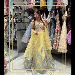 A vibrant yellow lehenga with unique, colorful leaf-pattern embroidery. This is a head-turner, perfect for a fun and festive daytime event.