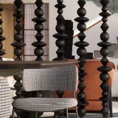 A detail of the dining area, where a screen of custom-turned wooden beads separates the space while maintaining visual connection. This element adds a layer of traditional craft to the modern design.