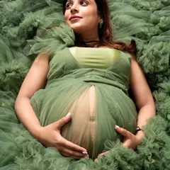 A quiet moment of connection with your baby. I designed this shot to feel like you are floating in a sea of dreams, surrounded by the soft ruffles of this gorgeous green gown from my collection.