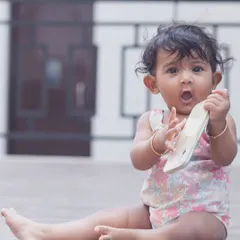 The best things in life come in small packages. This candid shot captures a baby's surprised and curious expression, a perfect memory of this fleeting stage.