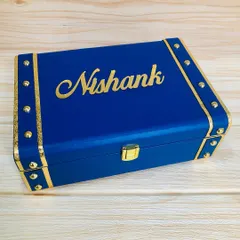 The exterior of a personalized trunk box, customized with the name 'Nishank' in elegant gold script. These trunks are perfect for creating high-end, bespoke hampers for weddings and other special events.