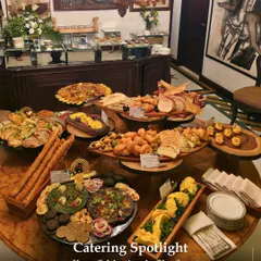 A stunning spread for a home celebration, featuring a round table laden with artisanal breads, dips, and savoury platters. This showcases our ability to create a grand buffet experience in an intimate setting.