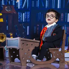 This little wizard, complete with round glasses, looks up in wonder, perfectly capturing the magic of the Harry Potter world.