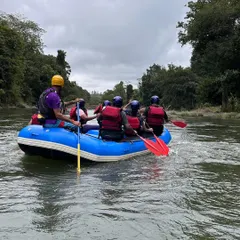 An instructor guides a team through a calm stretch of the river in Coorg. This view from behind shows the structured learning environment we provide on the water.