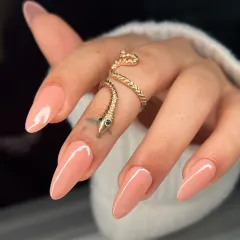 A close-up on the beautiful almond shape and the flawless application of this soft nude polish. It's a look of pure, simple elegance.