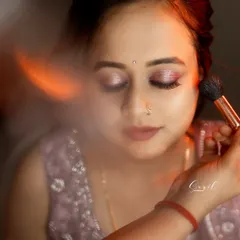An artistic shot of the makeup application for Raksha's reception. This shows the careful blending of eyeshadow to create a soft, shimmery look.