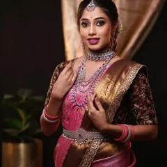 This image showcases the precise draping that allows the rich fabric and broad border of the saree to be displayed beautifully.