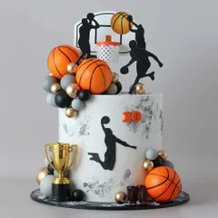A slam dunk of a cake! This basketball-themed creation is perfect for a sports fan's birthday, featuring player silhouettes, a hoop, and a trophy.