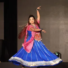 As a 'dancing anchor', my energy is my signature. This moment from the 'Rangilo Re' Navratri festival captures the pure joy and movement I bring to the stage, encouraging everyone from the youngest guest to the eldest dadi to join in the celebration and feel the rhythm.