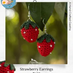 A close-up of my crochet strawberry earrings. I add tiny white beads for the seeds to make them look extra juicy and cute.