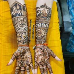 Here, the bride and groom are depicted in a traditional varmala (garland exchange) pose. The forearms are adorned with a baraat scene on one arm and a doli on the other, creating a complete wedding narrative.
