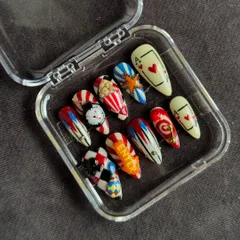 A still shot of the Vegas inspired set in its case. The combination of hand-painted details and 3D charms like the clock and 'Enter' sign makes this a truly one-of-a-kind set of custom nails.