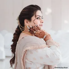 A stunning portrait of a client on her special day. The back-of-hand mehendi complements her traditional attire and elegant hairstyle perfectly.