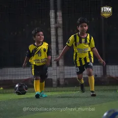 Two of our youngest players enjoying a training session under the lights. My goal is to make football a fun and positive experience from day one.