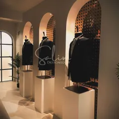 A glimpse into my studio's display area, where I showcase some of my finished tuxedos and jackets. This helps clients visualize the possibilities for their own custom garments.