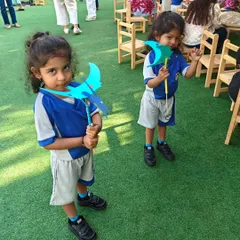 Two young creators proudly display the flying pterodactyls they just built. This activity combines history and physics into one exciting, hands-on project.