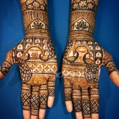A design for a peacock lover. This mehendi features majestic peacocks integrated with traditional 'jali' or net patterns and bold architectural shapes.