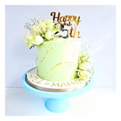 Celebrating 25 years of love is a huge milestone. This anniversary cake, with its soft pastel green frosting and fresh white flowers, was designed to be as beautiful as the journey it represents.