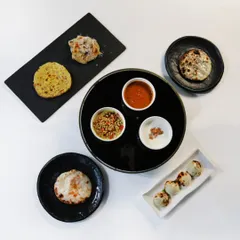 Another presentation of our bread bar, showcasing different types of kulchas and parathas on various plates. It’s a central part of the Indian Accent experience.