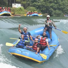 A group navigating the rapids of the Kali River. The thrill of working together as a team to paddle through the waves is an incredible bonding experience.