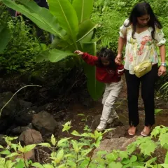 A helping hand from mom makes crossing a small stream an exciting part of the adventure. Our birthday trails are designed for all ages, ensuring everyone from toddlers to parents can participate and have fun.